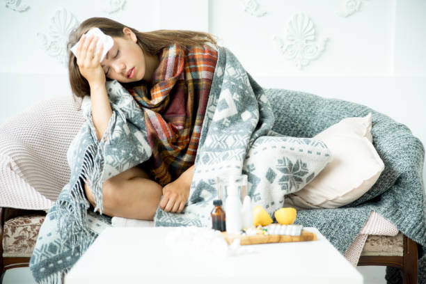 istock ill young girl with fever spending time at home 1022141012