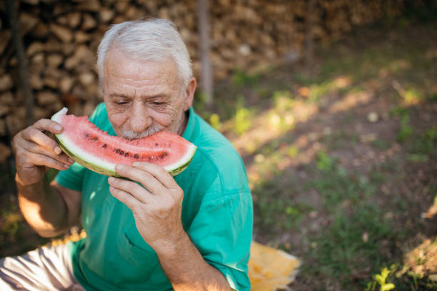 istock Senior man eating watermelon 1022141826