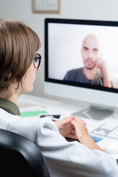 istock Digital health concept: practicing physician having online appointment with a patient. 1022148862