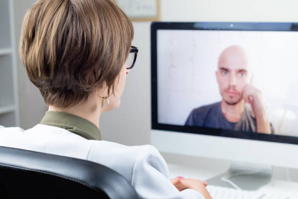 Digital health concept: practicing physician having online meeting with a patient.