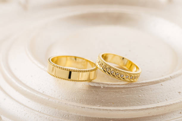 istock Two gold wedding rings on beige background 1022149180