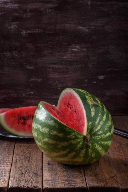 istock Sliced ripe watermelon on brown wooden table. 1022156890