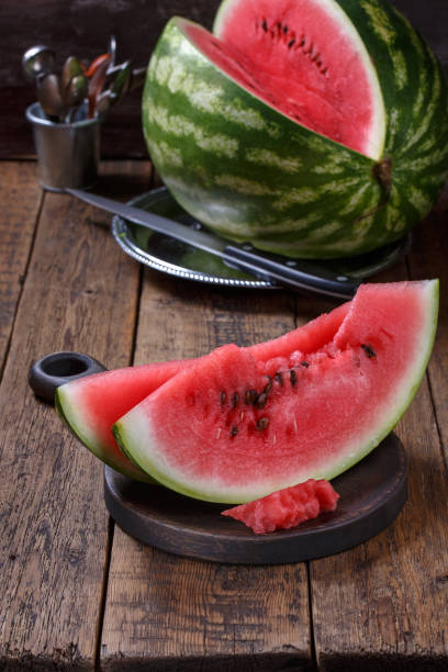 istock Sliced ripe watermelon on brown wooden table. 1022156904