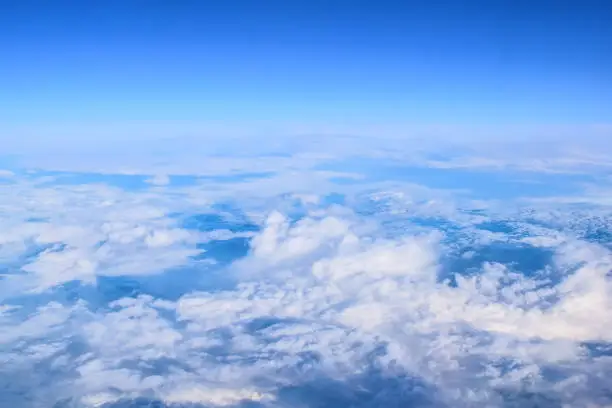 Aerial view of a thick layer of white clouds on a blue sky