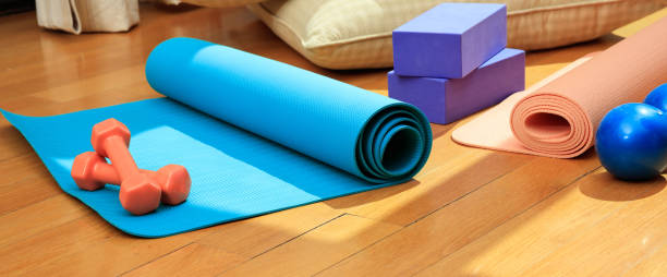 istock Yoga mat and exercise weights on wooden floor 1022159792