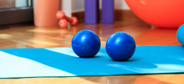 istock Yoga mat and exercise weights on wooden floor 1022159806