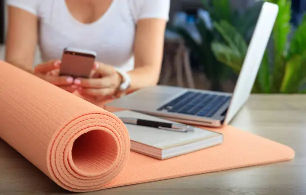Photo of Woman and an exercise mat in an office background