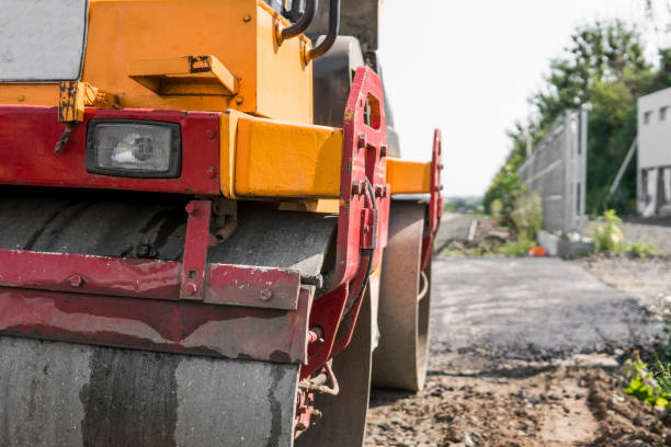 istock Orange Vibration roller compactor standing on a ground near asphalts road at road construction and repairing asphalt pavement works with a blue sky. 1022160364