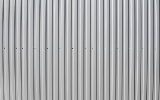 Metal white sheet for industrial building and construction on blue sky background. Roof sheet metal or corrugated roofs of factory building or warehouse