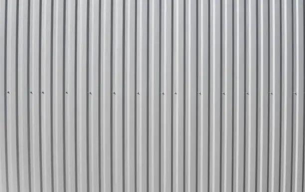 Photo of Metal white sheet for industrial building and construction. Roof sheet metal or corrugated roofs of factory building or warehouse.