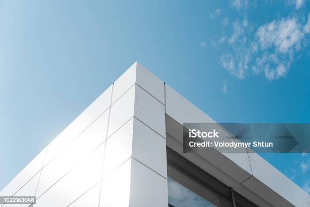 Building With White Aluminum Facade And Aluminum Panels Against Blue Sky Stock Photo - Download Image Now