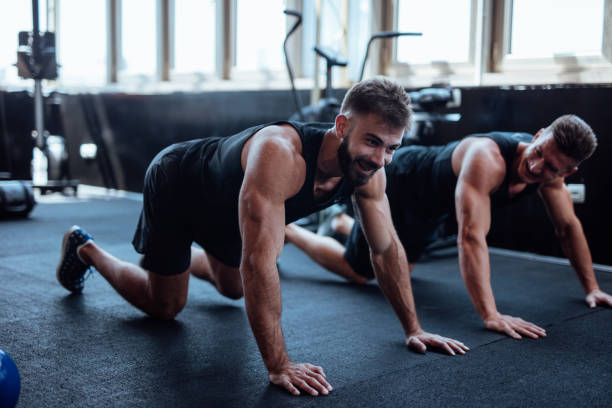 istock Two man doing push ups in the gym 1022167990
