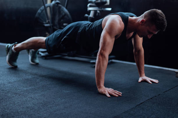 istock Man doing push ups in the gym 1022172236