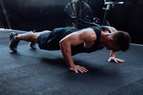 istock Man doing push ups in the gym 1022172314