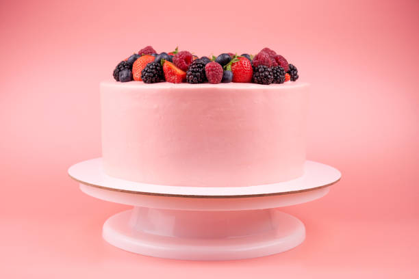 istock Cake with whipped pink cream, fresh strawberries, blueberries, blackberry and raspberry. 1022172924