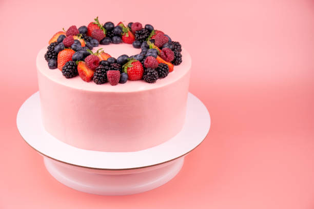 istock Cake with whipped pink cream, fresh strawberries, blueberries, blackberry and raspberry. 1022173120