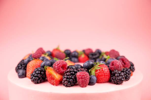 istock Cake with whipped pink cream, fresh strawberries, blueberries, blackberry and raspberry. 1022173144