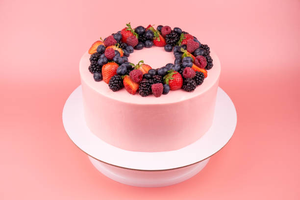 istock Cake with whipped pink cream, fresh strawberries, blueberries, blackberry and raspberry. 1022173196
