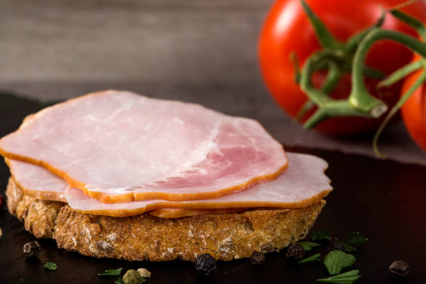 Open sandwich with pork smoked ham on a dark slate stock photo