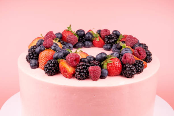istock Cake with whipped pink cream, fresh strawberries, blueberries, blackberry and raspberry. 1022173908
