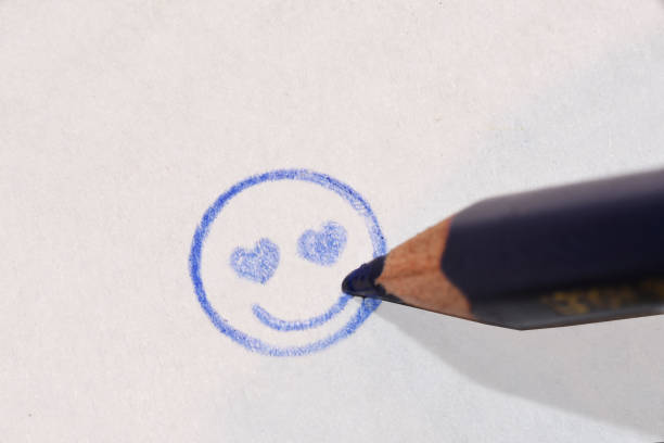 Drawing of smiley face with negative and positive expression with pencil and rubber - Negative emotion concept