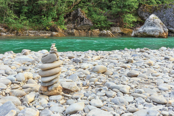 istock Pyramid of stones against a turquoise river 1022178868