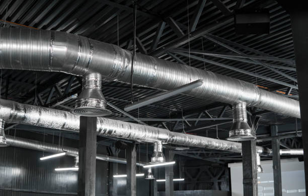 istock Ventilation system on the ceiling of large buildings. Ventilation pipes in silver insulation material hanging from the ceiling inside new building. 1022187704