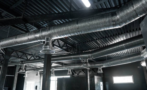 istock Ventilation system on the ceiling of large buildings. Ventilation pipes in silver insulation material hanging from the ceiling inside new building. 1022188002