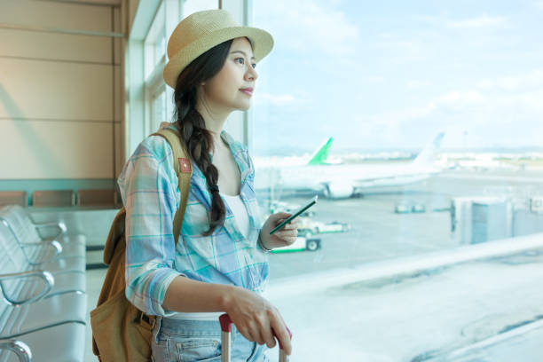 istock tourist watching at airport window 1022191618