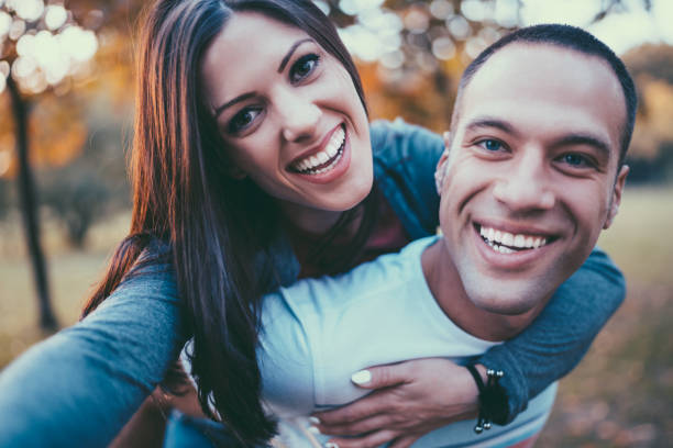 istock Couple taking selfie on piggyback 1022207230