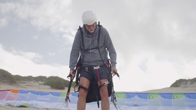 Man preparing paragliding equipment