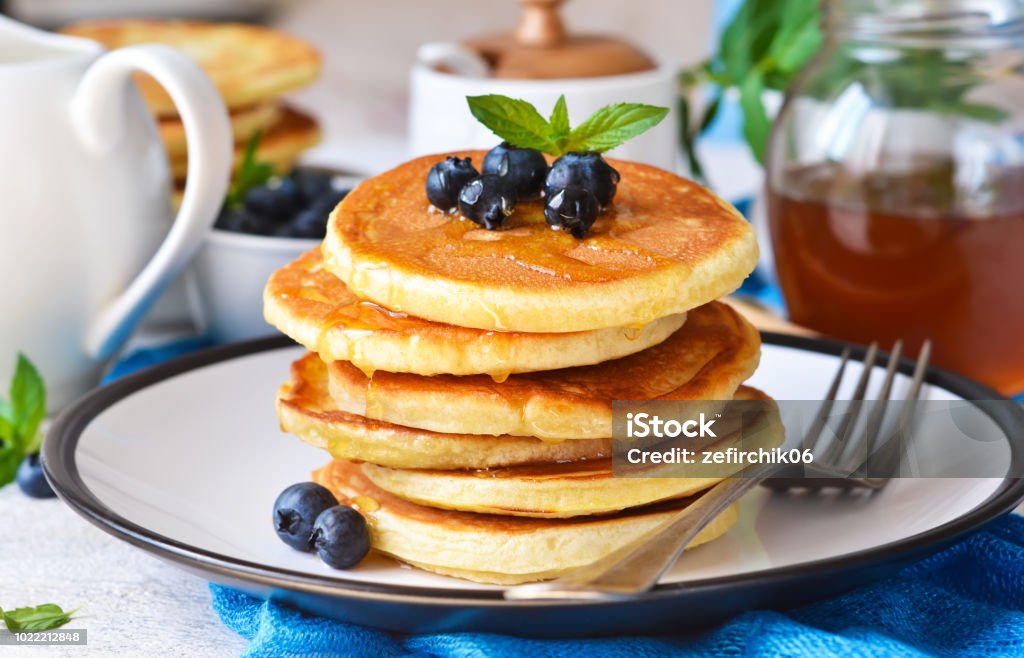 Homemade vanilla punkcakes with syrup and blueberries for breakfast. Good morning! Pancake Stock Photo