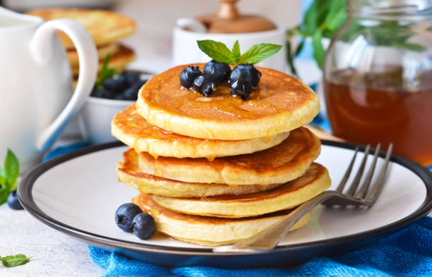 Homemade vanilla punkcakes with syrup and blueberries for breakfast. Good morning! stock photo
