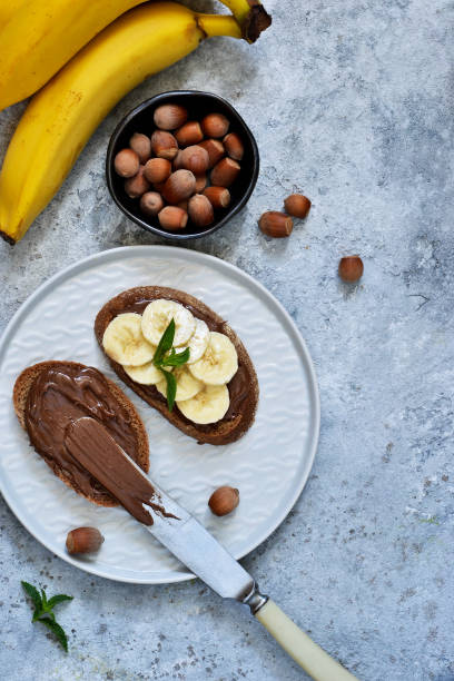 istock Grilled toast with chocolate paste and banana for breakfast on a concrete background. 1022212926