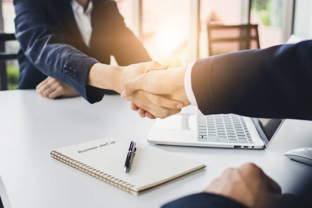 start up business people shake hands with investor before negotiating and planning to invest company together stock photo