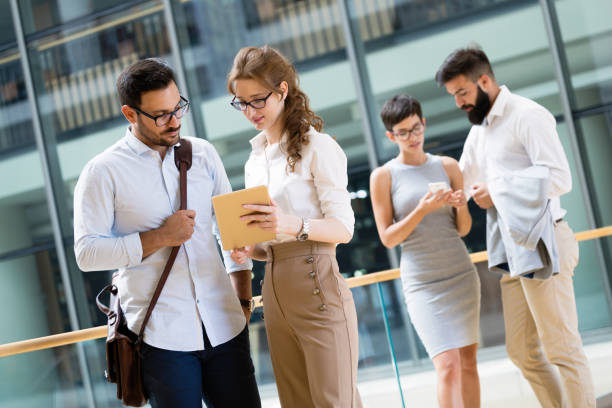 istock Happy business colleagues in modern office 1022215492