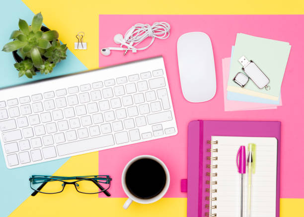 istock Office Desk Working Space Flat Lay. Top view photo of workspace with keyboard, notepad and coffee on pastel colored background. Student working desk concept. 1022215698