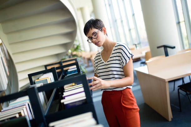 istock Happy woman at the library 1022215978
