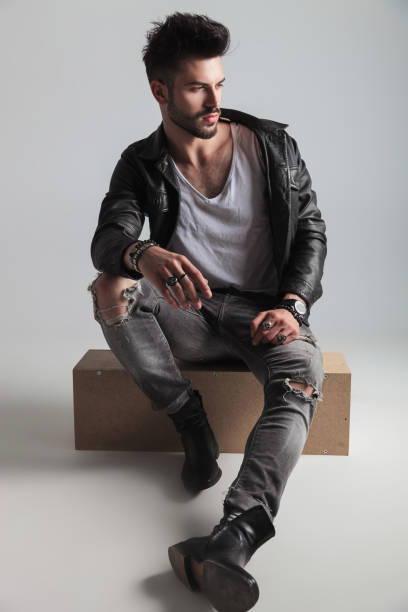 istock seated handsome man wearing black leather jacket looks to side 1022216026
