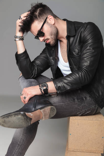 istock side view of man in leather jacket sitting and thinking 1022216132