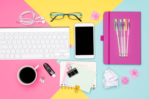 istock Office Desk Working Space Flat Lay. Top view photo of workspace with keyboard, notepad and coffee on pastel colored background. Student working desk concept. 1022216168