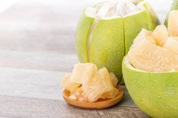 istock fresh and peeled pomelo(shaddock), grapefruit with slices on wooden table background 1022216222