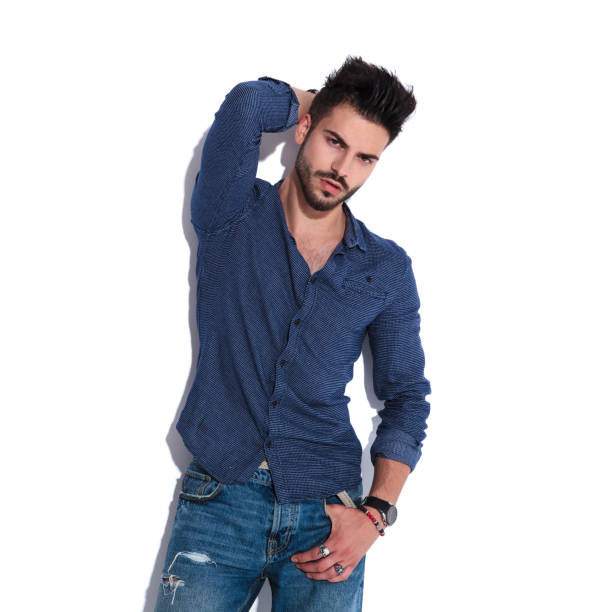 istock sensual man wearing a navy shirt posing while standing 1022216566