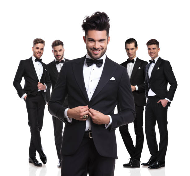 istock five attractive elegant men standing with leader buttoning his suit 1022218760