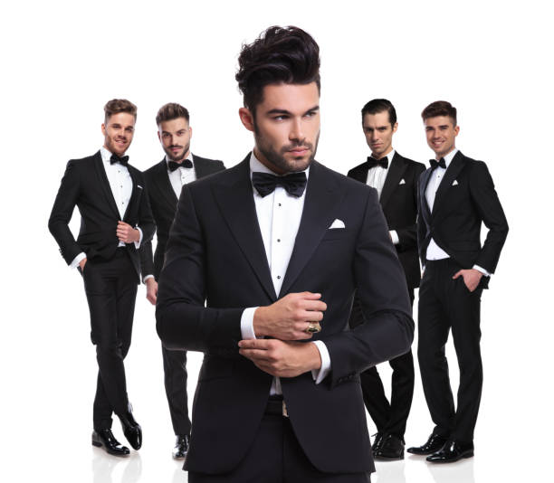 istock elegant leader fixes his sleeves in front of his team 1022218980