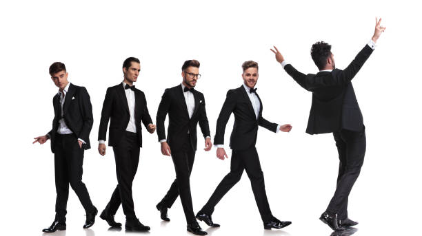 istock five elegant men walking in different directions and one celebrating 1022219012