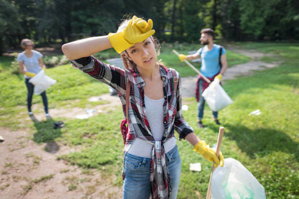 istock Woman volunteering in community cleaning project 1022219438