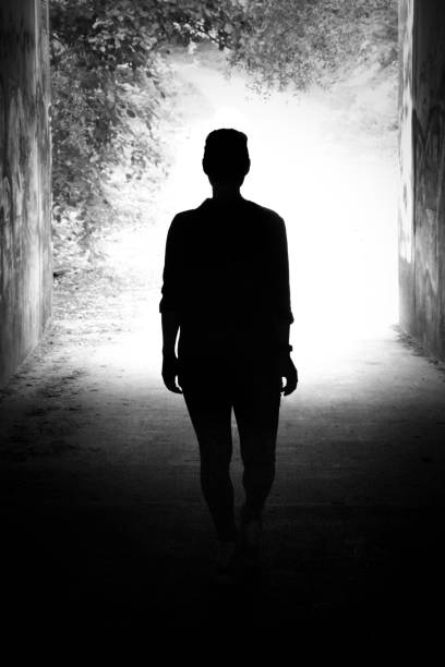 istock Silhouette of a young woman in backlight 1022224258