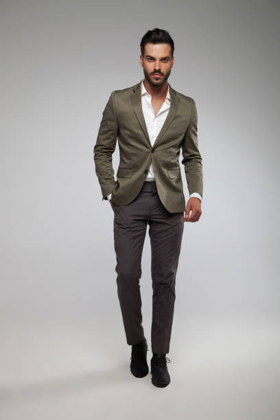 istock sexy man in grey suit walking forward 1022224876