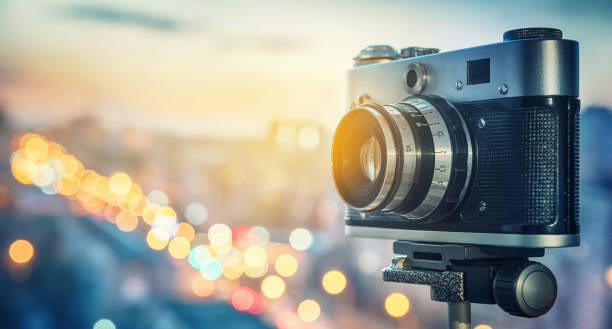 istock Retro camera on night city background. 1022234442
